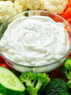 A close up photo of a veggie tray with dip