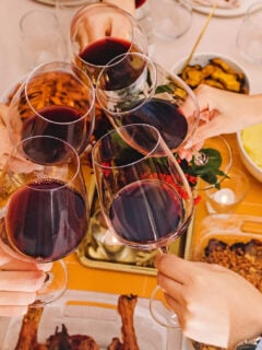 Red wine cheers over a Thanksgiving dinner table