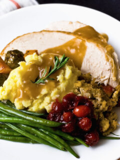 Traditional turkey dinner with cranberry sauce and stuffing and all the trimmings.
