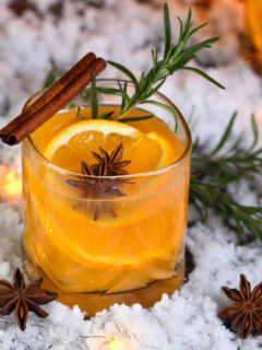 Negroni cocktail. Gin with cinnamon with oranges juice and star anise. The perfect cozy cocktail for chilly December evenings.