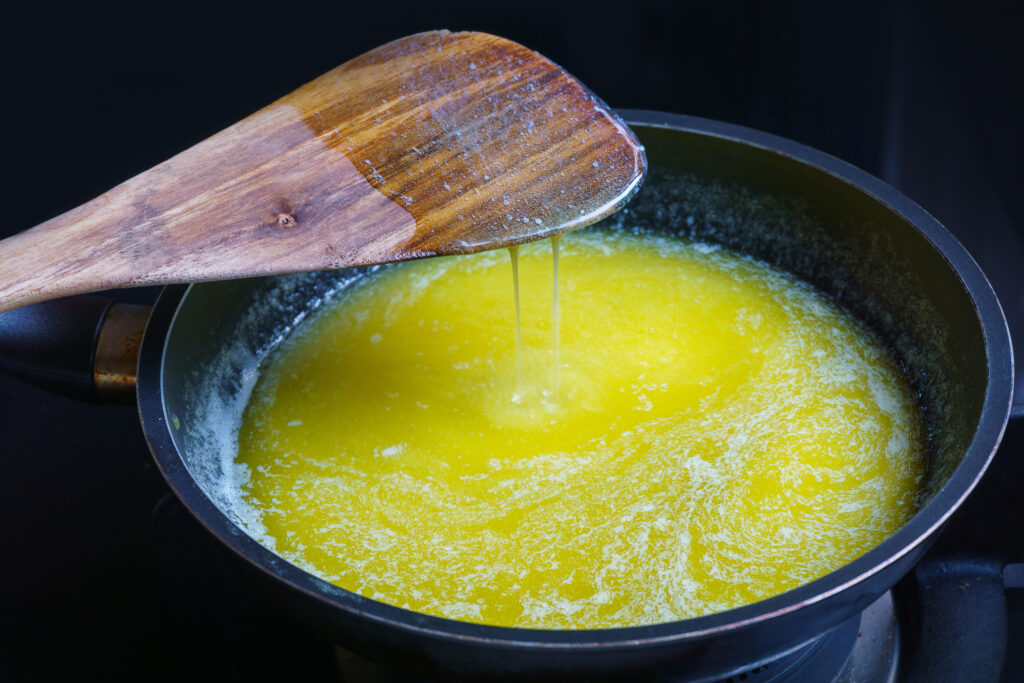 Melted butter in a pan with a wooden spoon