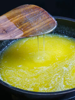 Melted butter in a pan with a wooden spoon