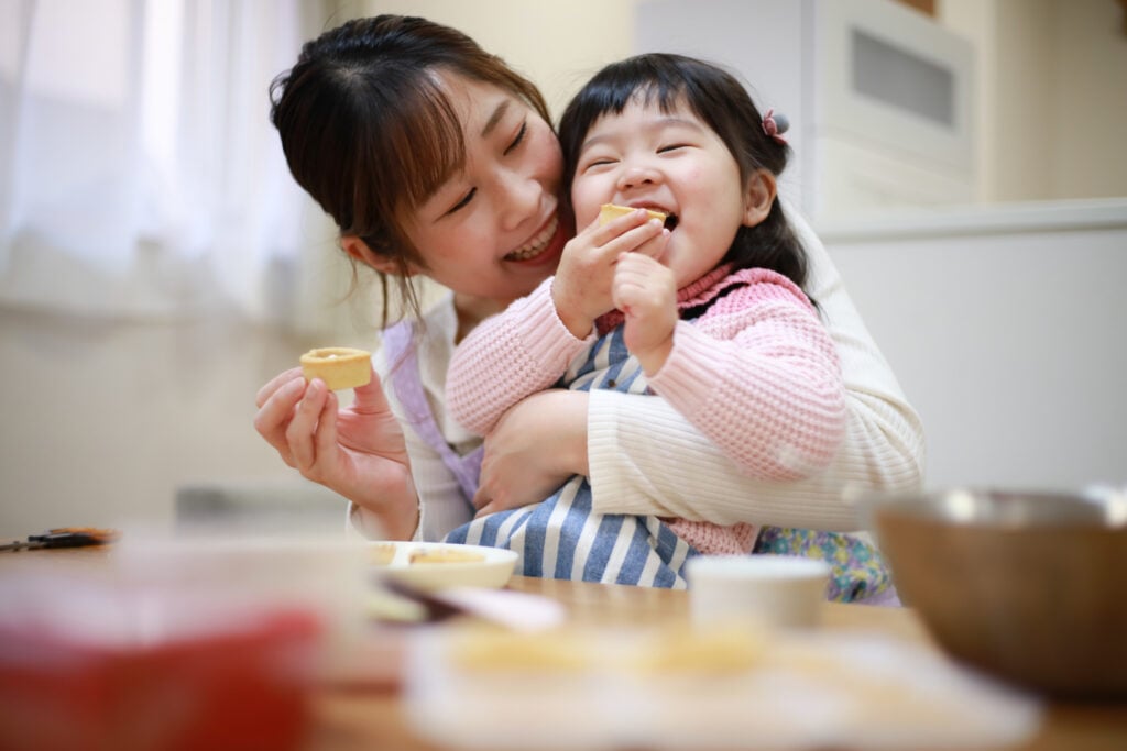 Parent and child eating a snack together