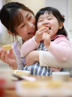 Parent and child eating a snack together