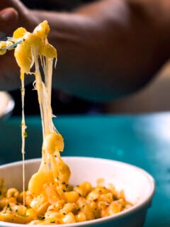 Eating a bite of cheesy macaroni and cheese
