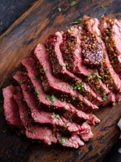 Corned beef cooked and sliced on a cutting board, irish recipe idea for St Patricks day