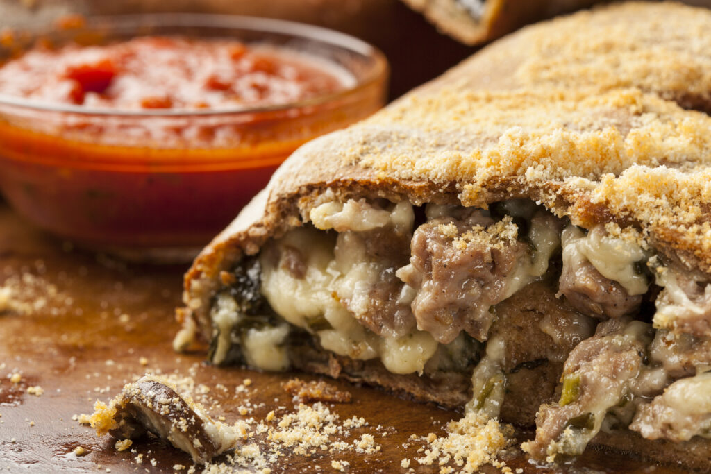Fresh Homemade Italian Calzone with sausage and spinach