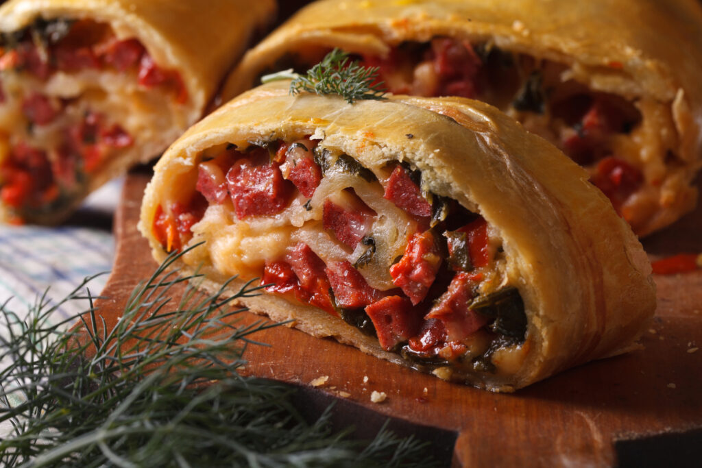 homemade strudel with ham, cheese and fresh vegetables