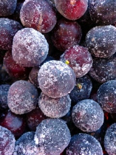 Destemmed and frozen red grapes, close up