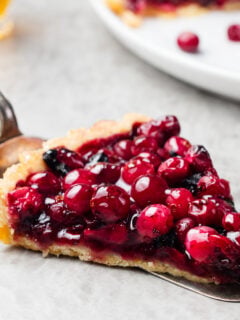 Tart, pie, cake with jellied fresh cranberries, bilberries and winter spices
